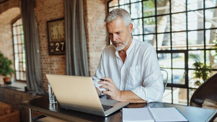 A man completes a Roth conversion on his laptop. 