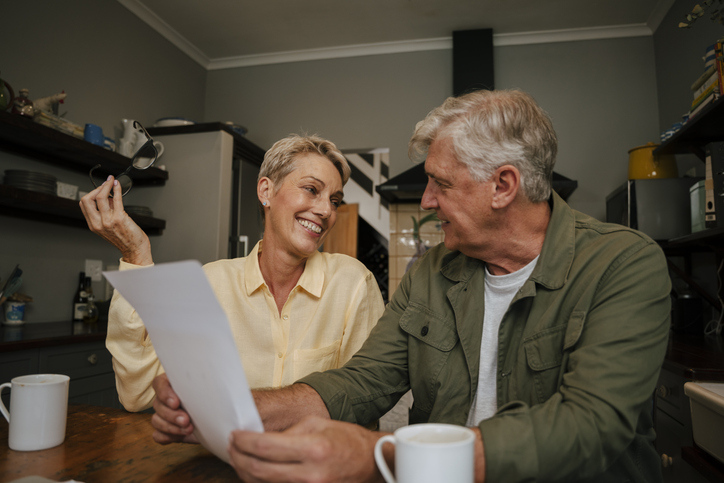 A senior couple reading the terms for their annuity.